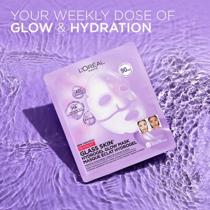 A single purple L'Oréal Paris Hydrogel Mask packet resting on a wet, rippled water texture with the text: "Your Weekly Dose of Glow & Hydration".