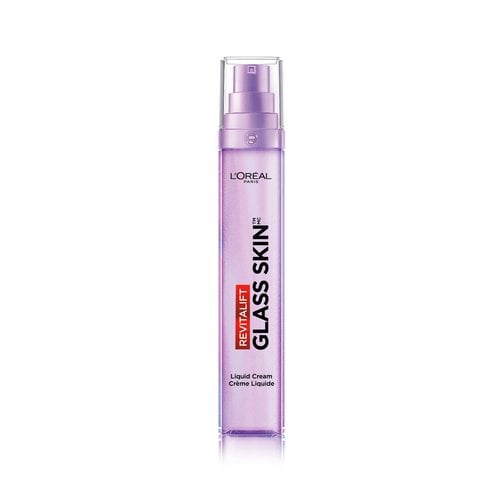 A medium shot of the purple L'Oréal Paris Revitalift Glass Skin pump bottle on a clean white background, positioned next to a smear of smooth, silky white liquid-cream texture.
