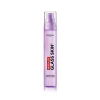 A medium shot of the purple L'Oréal Paris Revitalift Glass Skin pump bottle on a clean white background, positioned next to a smear of smooth, silky white liquid-cream texture.
