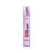 A medium shot of the purple L'Oréal Paris Revitalift Glass Skin pump bottle on a clean white background, positioned next to a smear of smooth, silky white liquid-cream texture.