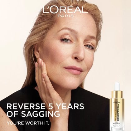 Portrait of brand ambassador Gillian Anderson looking up confidently, resting her hand on her neck. Text reads: "REVERSE 5 YEARS OF SAGGING. YOU'RE WORTH IT." A small product bottle is shown in the bottom right corner.